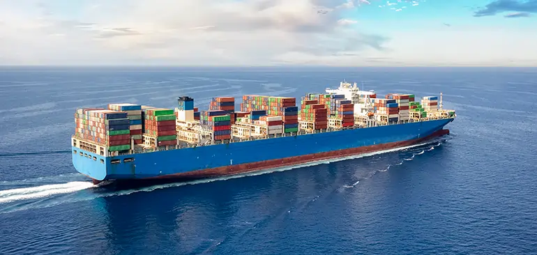 Container ship sailing across the ocean for international sea freight